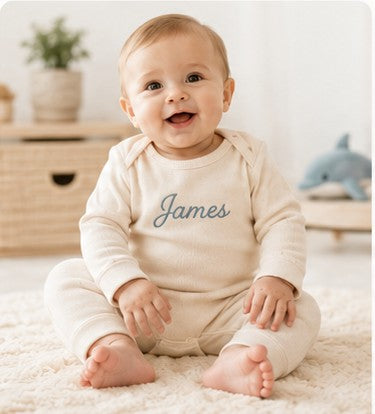 Baby in a personalized Nuvermi outfit