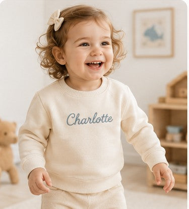 Toddler in a personalized Nuvermi sweater