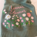 Cream knit baby blanket embroidered with a name and wildflowers